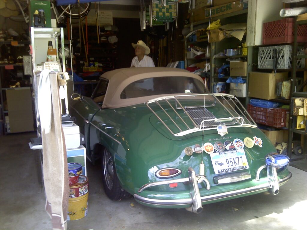 Old green Porsche in garage